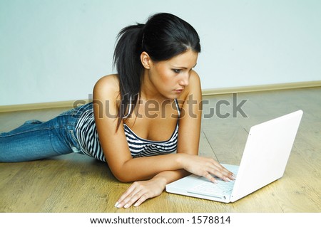 Young pretty women on wooden floor relaxing and using laptop computer Royalty-Free Stock Photo #1578814