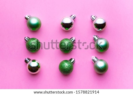 Xmas background. Christmas decoration balls isolated on pink. Abstract winter concept. Flat lay