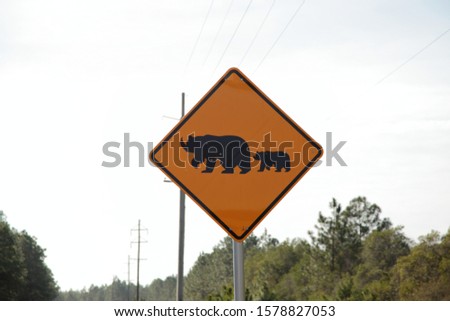 Bears crossing the road appear as rhinoceros crossing the road warning sign