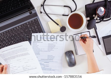 Close-up of a female doctor working in office. 