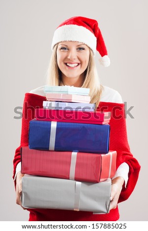 Cheerful woman is holding a lot of gifts and she is very happy about it,,It` time for presents!