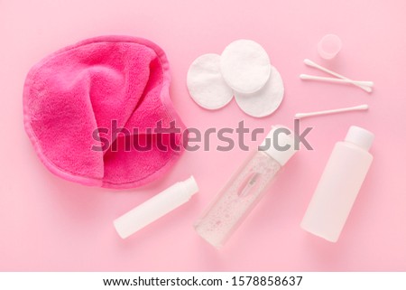 make up remove products, micellar water, face cleaning cloth, cleansing milk and gel with cotton pads on pastel pink background Royalty-Free Stock Photo #1578858637