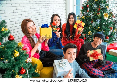 Merry Christmas and Happy Holidays! Group of funny and happy five young Asian teen friends celebrate christmas, Group happy of friends laughing and sharing Christmas gifts.