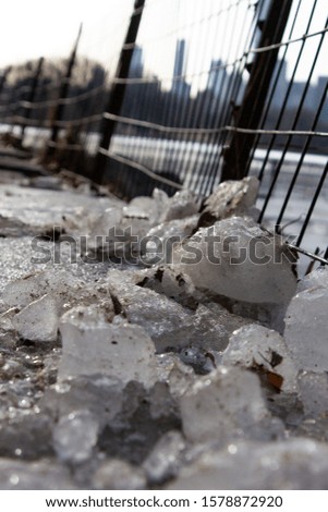 Close-up of some ice rocks near a fence at Central Park, New York City