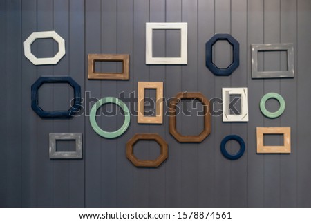 Beautiful group of wooden frame various shapes on the gray wooden wall