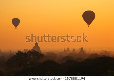 Hot air ballons over the ancient temples and colorful sunset in Bagan, Myanmar
