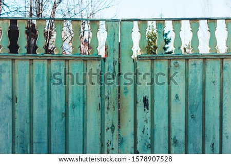 Wooden fence of boards to protect the territory of the house