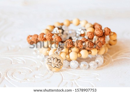Jewelry mala necklace with natural mineral beads on white wooden decorative background