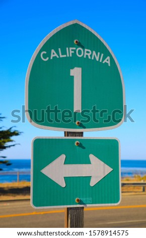 California highway. Green sign on the street against blue sky. California, United States
