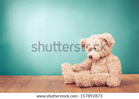 Teddy Bear toy alone on wood in front mint green background Royalty-Free Stock Photo #157892873