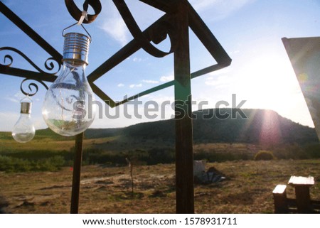 Light Bulb hanging from steel frame