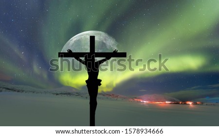 Jesus on the cross on the background full moon -Northern lights (Aurora borealis) in the sky over Tromso, Norway "Elements of this image furnished by NASA"
