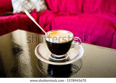 small glass of American coffee with teaspoon, homemade