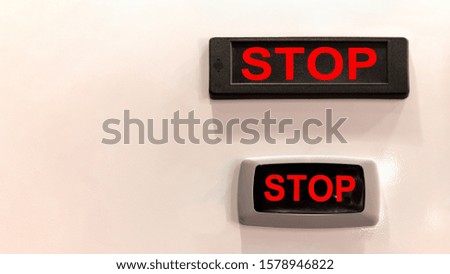 Two information signs prescribing stops are written in red letters on a black plaque in English.