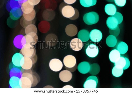 Bokeh images with green, orange, red, purple lights on a black background.