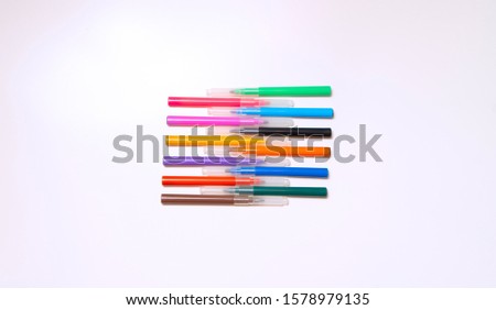 Colorful felt-tip pens on the white background. Markers and pencils pattern. Background or texture.