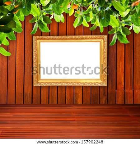 Wall with photo frames and branches.