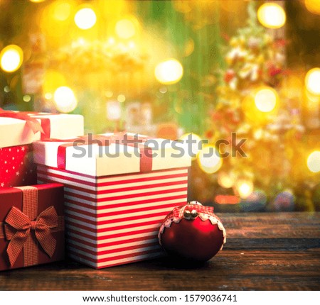 gift boxes and blurred background of Christmas tree in home interior