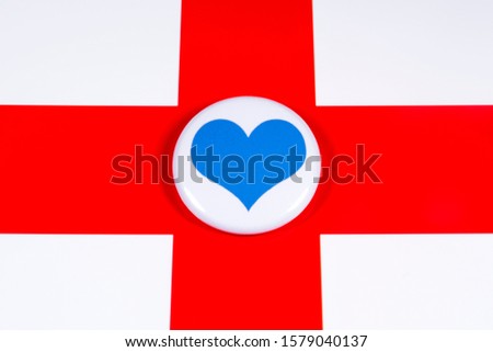 A blue heart symbol, pictured over the flag of England.