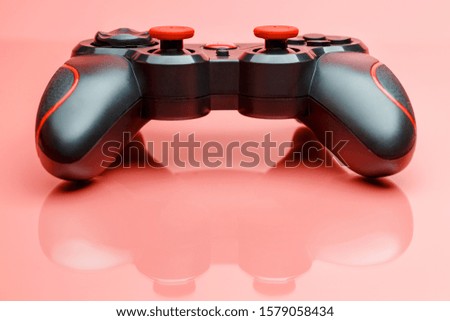 Game controller gamepad on pink background with . Device to control and control the game