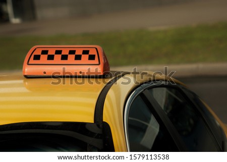 Yellow taxi car with a checkered
