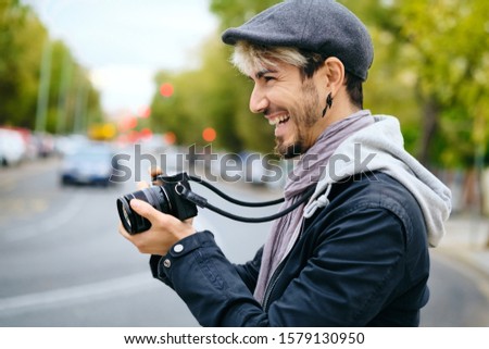 Hipster Photographer Taking Street Pictures With Mirrorless Camera