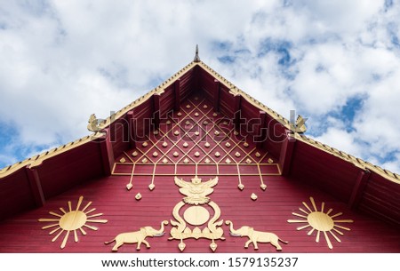 Carved garuda and elephant pattern in the traditional Thai style on the gable of the Thai church.(Public area not required Property Release)
