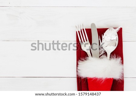 Festive table setting on a white wooden background. The concept of Christmas and New Year parties. Place for text. Flat layout.