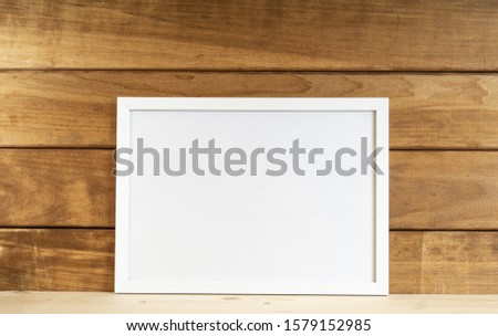 Mockup white frame on wooden background. Horizontal
