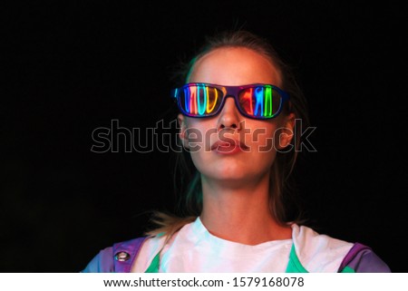 Image of beautiful young caucasian woman in 3D glasses watching movie in dark cinema room