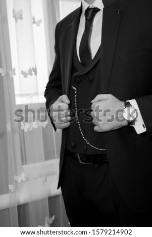 Elegant man in a black suit
Photo of a stylish man in an elegant black suit