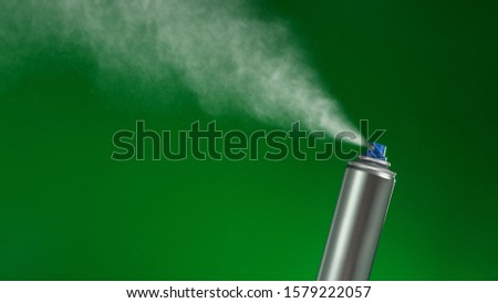 VFX plate photo of spray can with blast on green background, fountain of vaporized foam particles Royalty-Free Stock Photo #1579222057