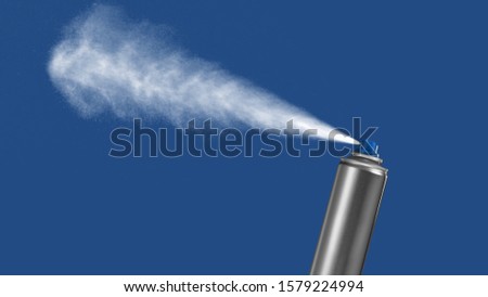 VFX plate photo of spray can with blast on blue background, fountain of vaporized foam particles Royalty-Free Stock Photo #1579224994