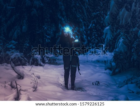 Fairytale winter forest. Astronaut girl in space helmet. Young girl in an astronaut suit. Space helmet. Background wallpaper. Another world. Wild Survival. Space people. Mystical atmosphere