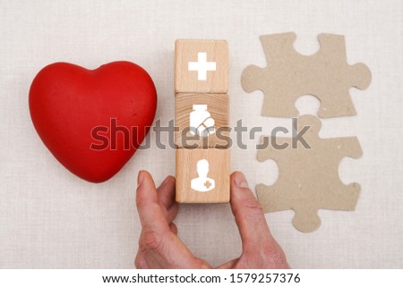 Doctor hand arranging wood block stacking with icon healthcare, insurance for your health.