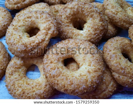 
Close-up of cookies, tasty, homemade, fresh, shortbread, sprinkled with sugar, round in shape against an abstract wooden surface