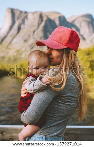 Mother and infant baby together family traveling in mountains healthy lifestyle young woman mom holding child summer vacations outdoors Mothers day