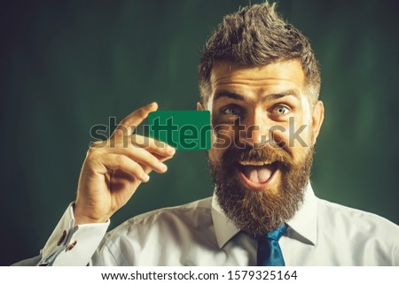 Business man presenting creditcard. Business branding. Serious bearded man with blank business card in hand. Businessman shows credit card or empty visiting card. Credit card as secure online payment.