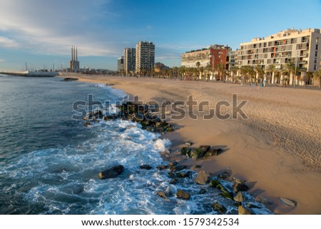 Badalona Beach near Barcelona, Spain. Badalona city view and Powerful Waves Royalty-Free Stock Photo #1579342534