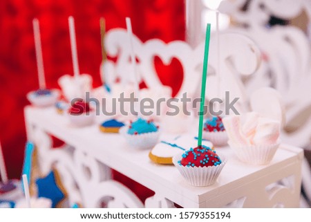 closeup of cupcakes on white stand. candy bar for first birthday.