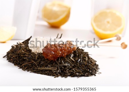 Two sugar sticks on a bed of green tea