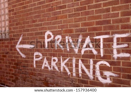 Private parking signage at the entrance of a home apartment building.