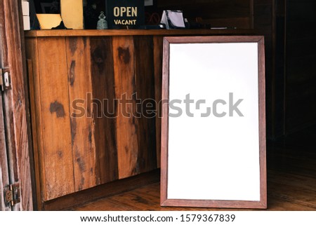 Mock up white Label blank advertising billboard for wood frame front restaurant cafe at hotel on old wooden background display your product insert  text. retro vintage decoration style