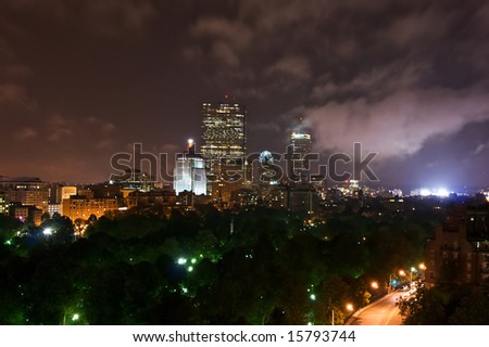 beautiful night image of the boston skyline above the boston common glowing by the lights of the buildings and streetlamps