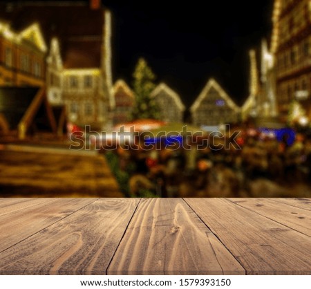 rustic wood table in front of christmas light night