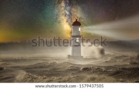 Lachine Lighthouse under a starry night sky with a storm pounding the beacon, Quebec, Canada.