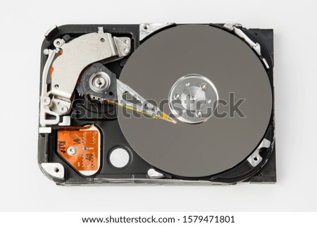 hard drive disassembled on a gray background