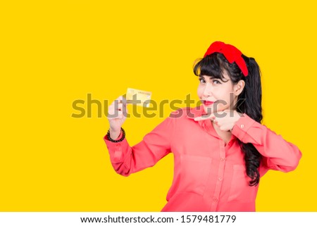 Young smiling Asian woman presenting credit card in hand showing trust and confidence for making payment,Reliable financial company
