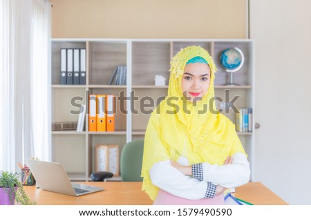 Selective focus of Happiness young business arab middle eastern muslim woman in office
