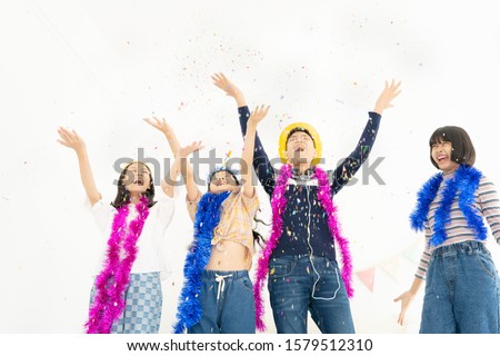 Group of children play with air balloons, confetti in light room on party, happy childhood concept